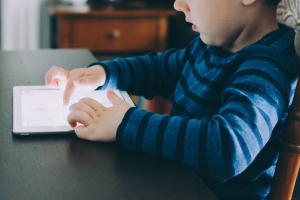 Παιδί με τάμπλετ κάνει τηλεκπαίδευση