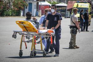 Διασώστης μεταφέρει σε φορείο διασωθέντα από το ναυάγιο στην Πύλο