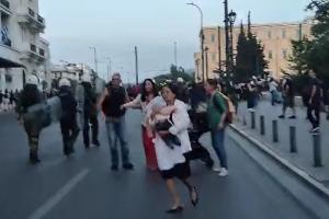 Τουρίστια με το μωρό στα χέρια φεύγει από τα ΜΑΤ