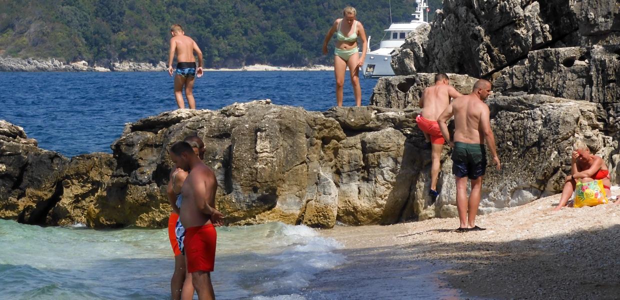 Κόσμος κάνει μπάνιο σε παραλία