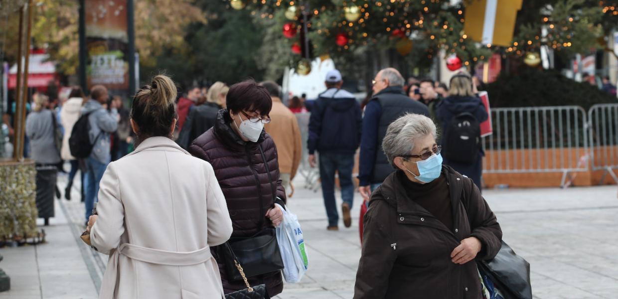 Κόσμος με μάσκα μπροστά από το χριστουγεννιάτικο δέντρο στο Σύνταγμα