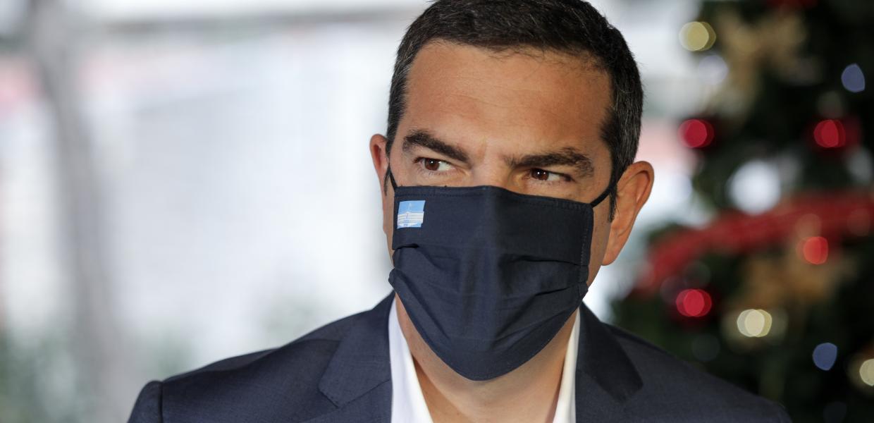 Ο Αλέξης Τσίπρας με μάσκα μπροστά σε χριστουγεννιάτικο δέντρο
