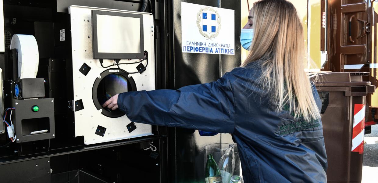 Κοπέλα βάζει σκουπίδια σε κάδο ανακύκλωσης 