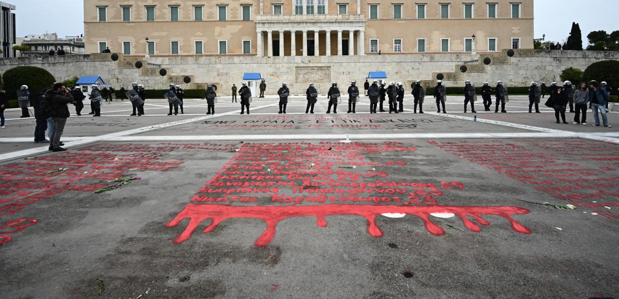 Τα ονόματα των νεκρών των Τεμπών γραμμένα με κόκκινη μπογιά μπροστά από την Βουλή