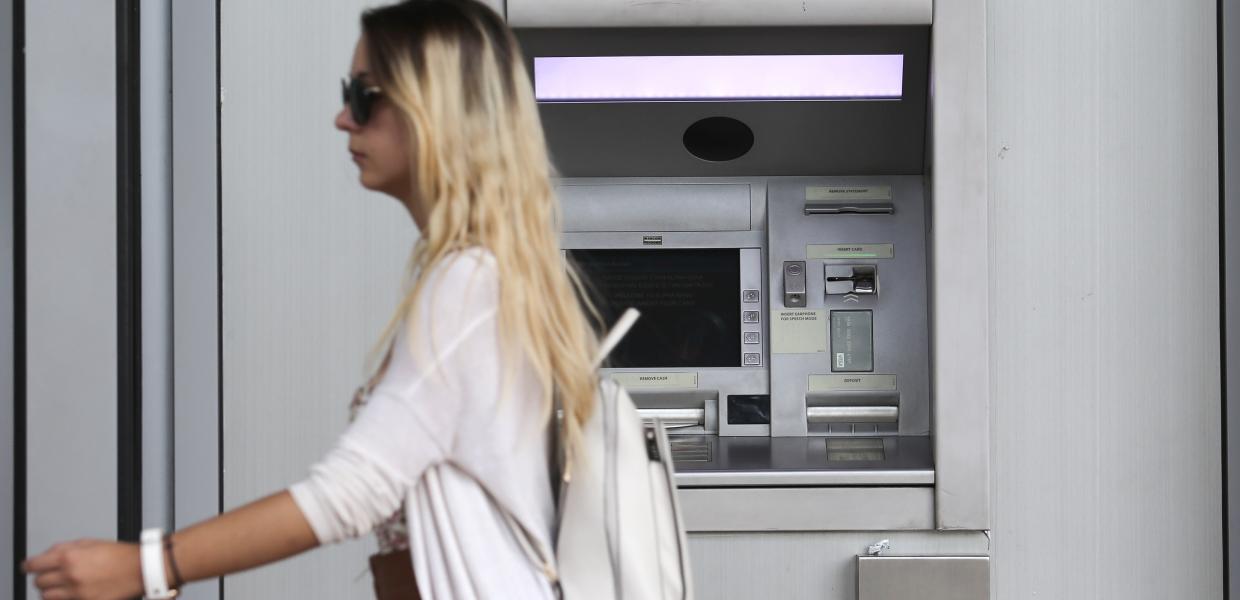 Γυναίκα μπροστά από ΑΤΜ