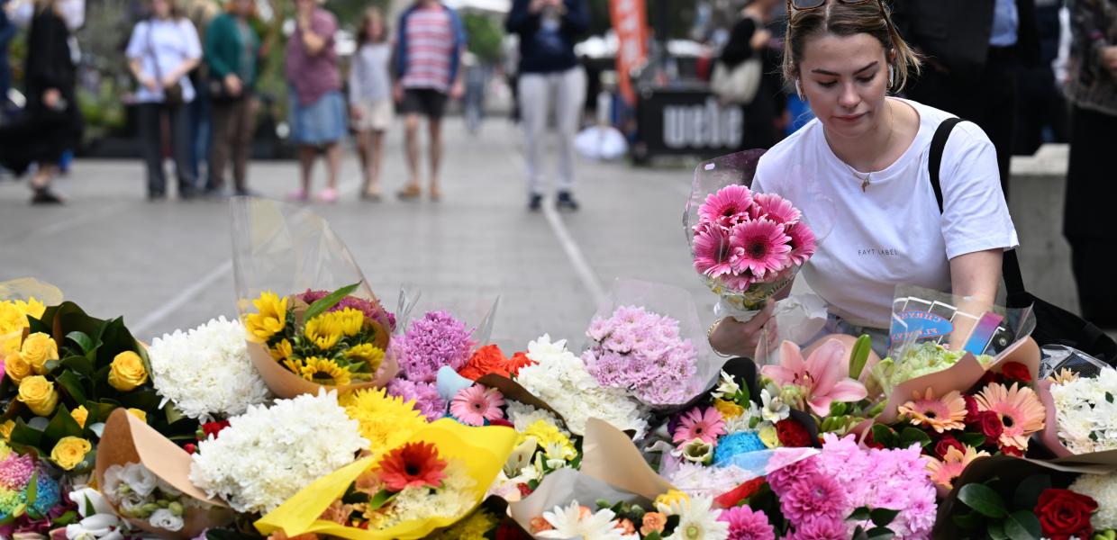Γυναίκα αφήνει λουλούδια για τα θύματα της επίθεσης στο εμπορικό κέντρο, Σίδνεϋ