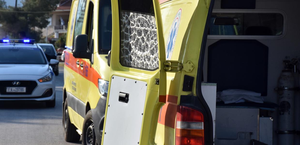 Ανοιχτή πόρτα ασθενοφόρου και πίσω περιπολικό
